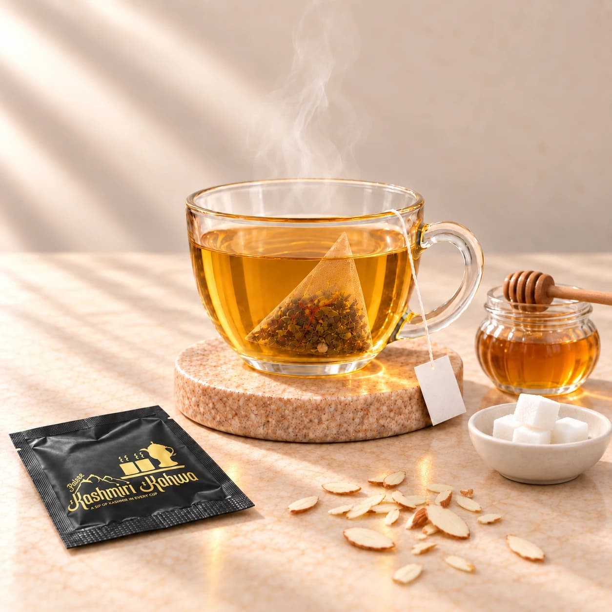 A steaming cup of golden Kahwa with a jar of honey, a bowl of sugar cubes and slivered almonds beside it
